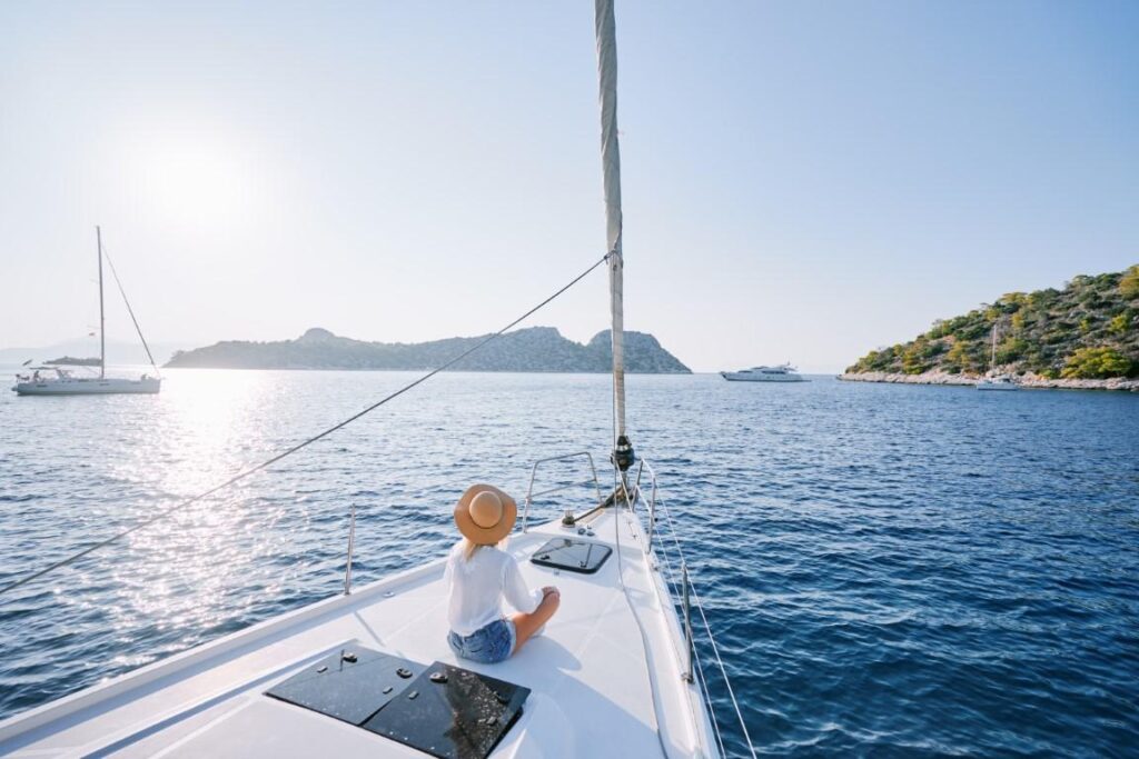 Relaxing on a sailboat during a peaceful weekend boat trip at sunset.