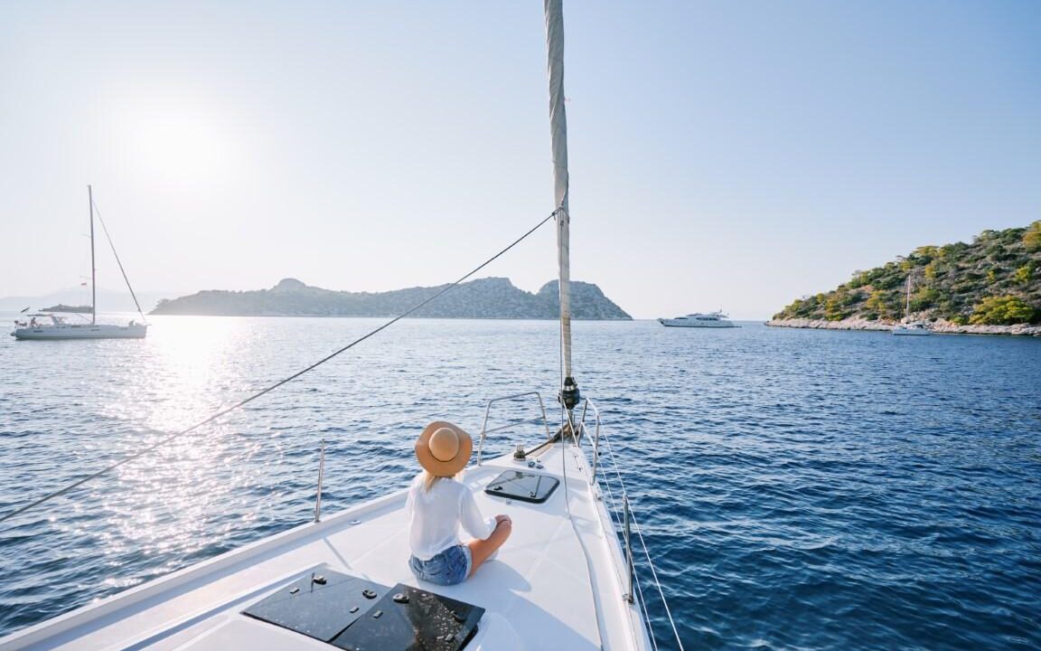 Relaxing on a sailboat during a peaceful weekend boat trip at sunset.