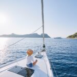 Relaxing on a sailboat during a peaceful weekend boat trip at sunset.