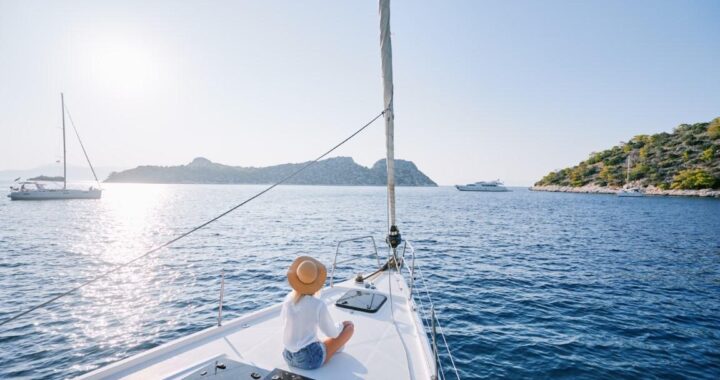 Relaxing on a sailboat during a peaceful weekend boat trip at sunset.