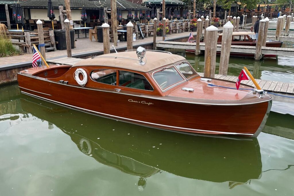 Vintage wooden boat moored in a Chesapeake Bay marina where restored classics continue attracting premium private charter bookings.