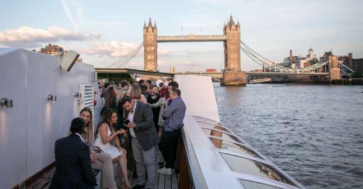 Guests enjoying a private charter boat experience on the River Thames in London.