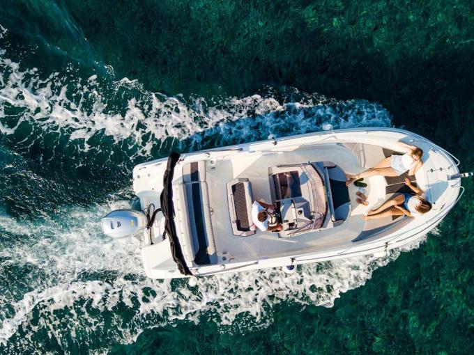 Modern water taxi transporting tourists across crystal-clear Adriatic waters between coastal destinations.