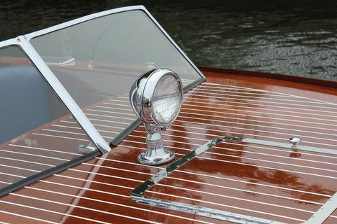 Hand-polished mahogany deck and chrome fittings on a restored classic Chris-Craft, highlighting the craftsmanship behind luxury vintage boat charters.