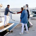 First-time guests boarding a private boat charter with a licensed captain at the marina.