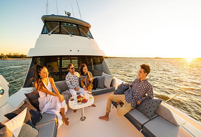 Guests enjoying a successful fishing charter aboard a center console boat.