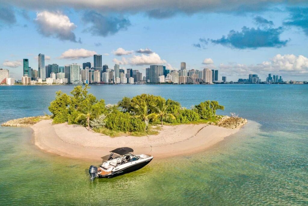 Private charter boat cruising across Biscayne Bay with Miami's skyline visible in the distance.
