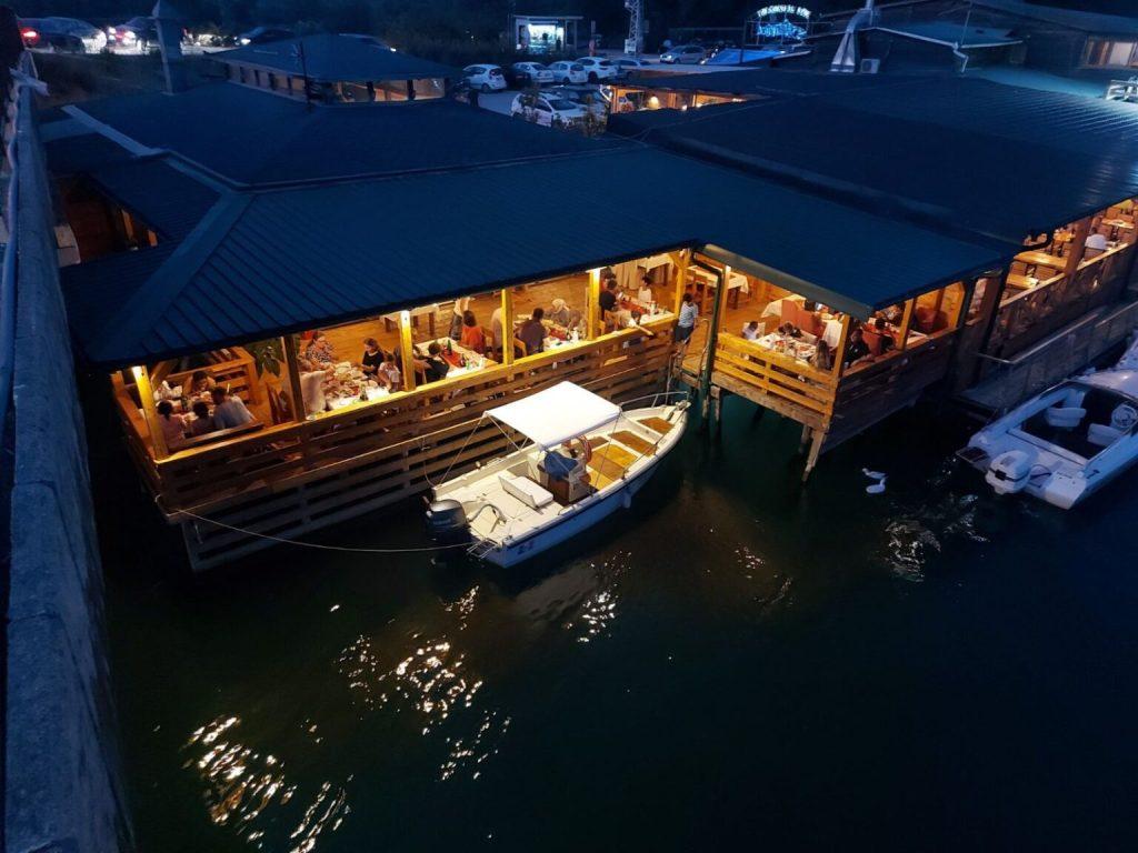 Water taxi arriving at a waterfront restaurant with a private dock.