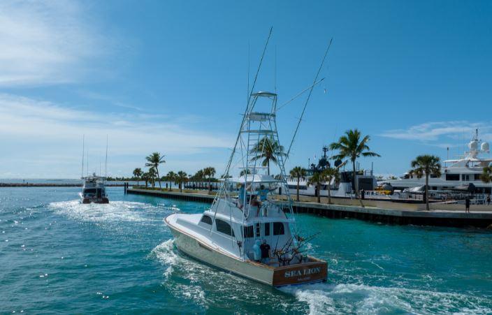 Boat owner taking photos of a boat before publishing an online rental listing.