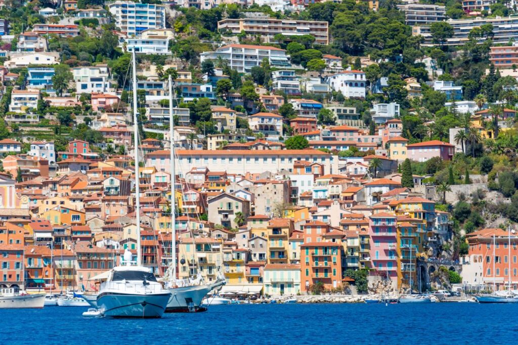 Luxury yachts framed by the colorful waterfront of Villefranche-sur-Mer.