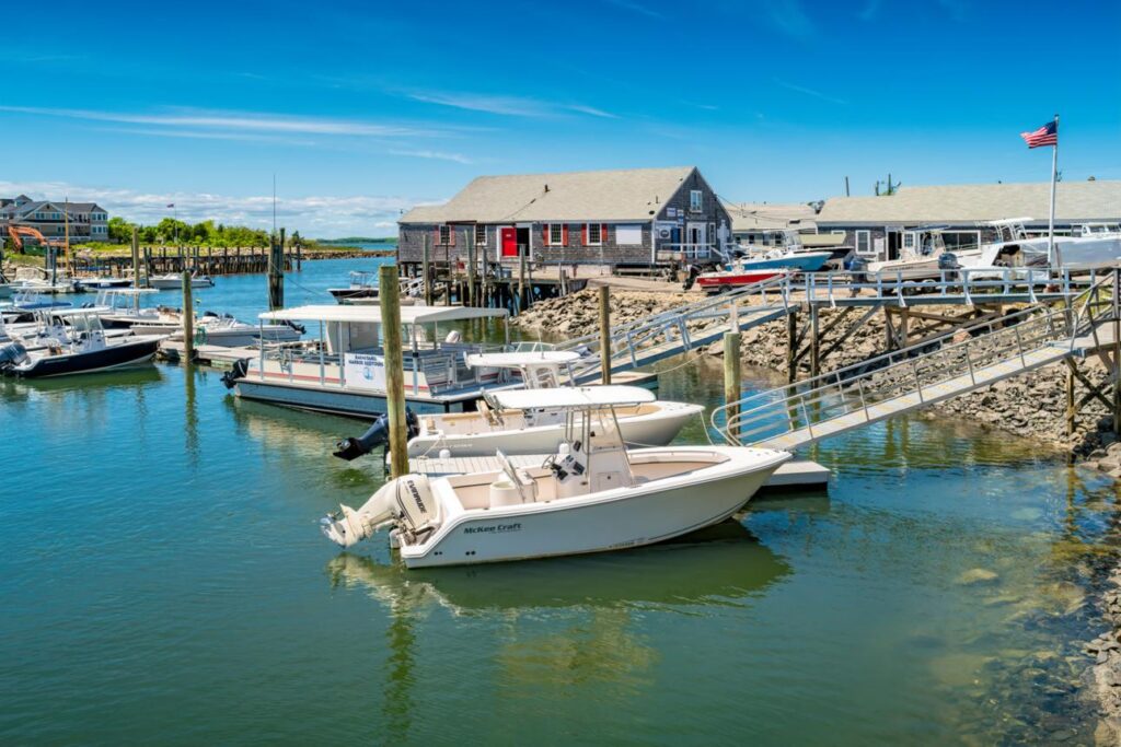 Small coastal marina filled with locally owned charter boats representing the backbone of America's independent water tourism economy.