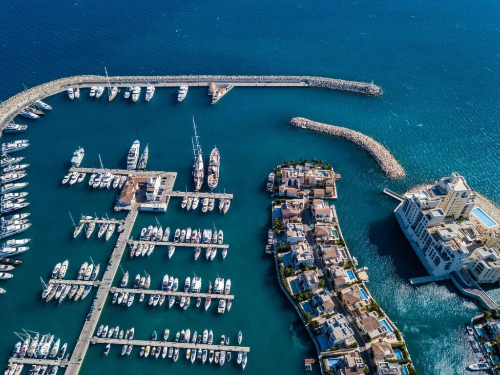 Modern marina filled with privately owned boats representing the growth of the peer-to-peer boat rental economy in 2026.