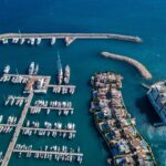 Modern marina filled with privately owned boats representing the growth of the peer-to-peer boat rental economy in 2026.