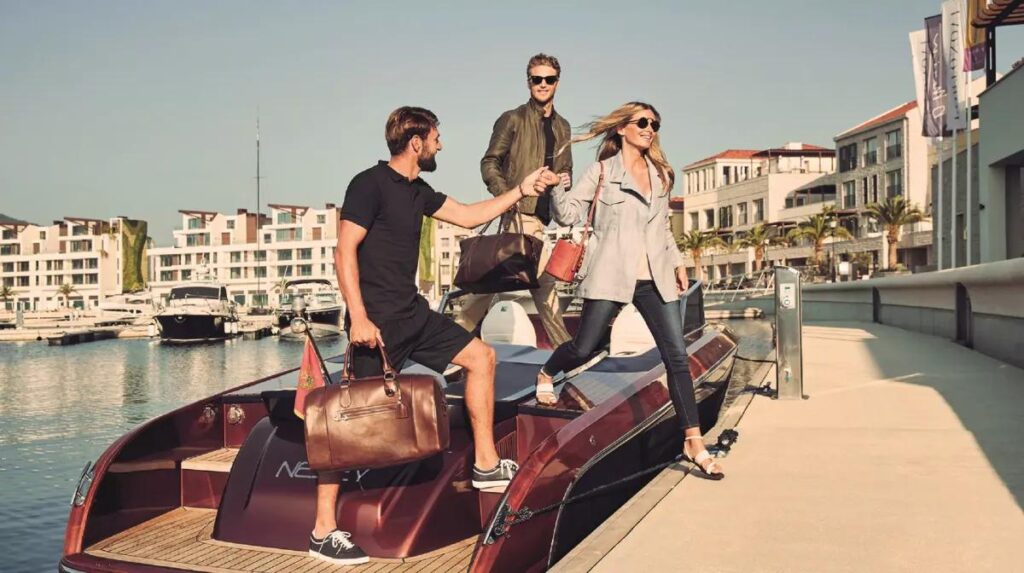 Tourists boarding a water taxi at a marina instead of using traditional land transport.