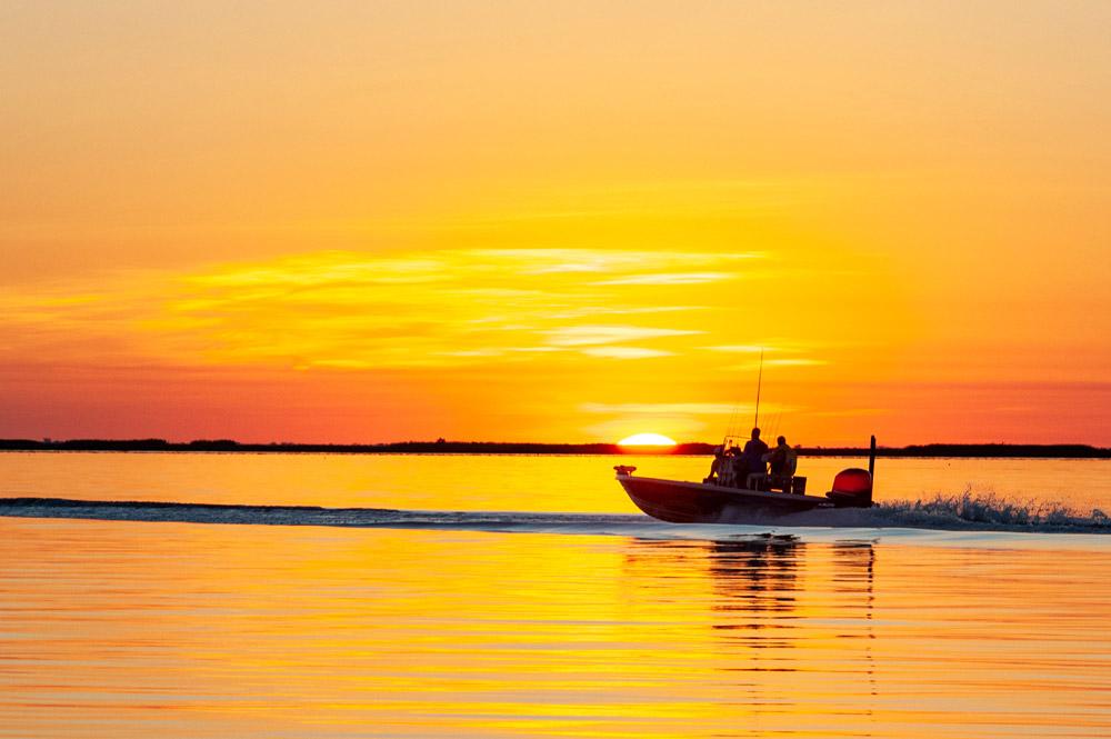 Fishing boat on Lake Pontchartrain during sunrise near New Orleans.