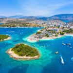 Aerial view of the Albanian Riviera with turquoise Ionian waters and untouched coastline near Ksamil.