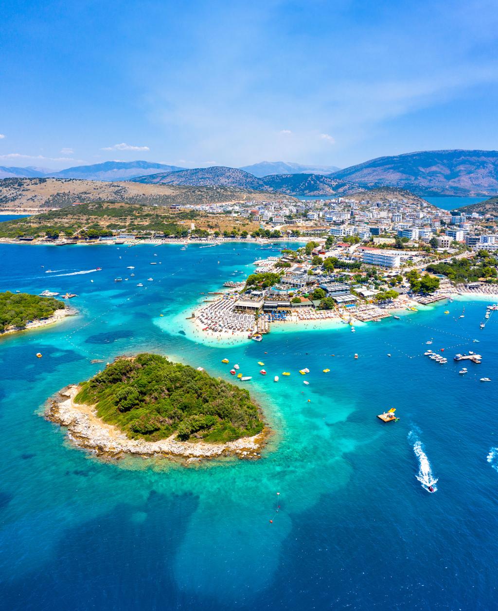 Aerial view of the Albanian Riviera with turquoise Ionian waters and untouched coastline near Ksamil.