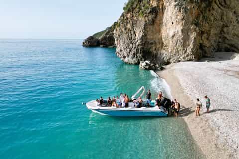 Water taxi arriving at a secluded beach that can only be reached by boat.