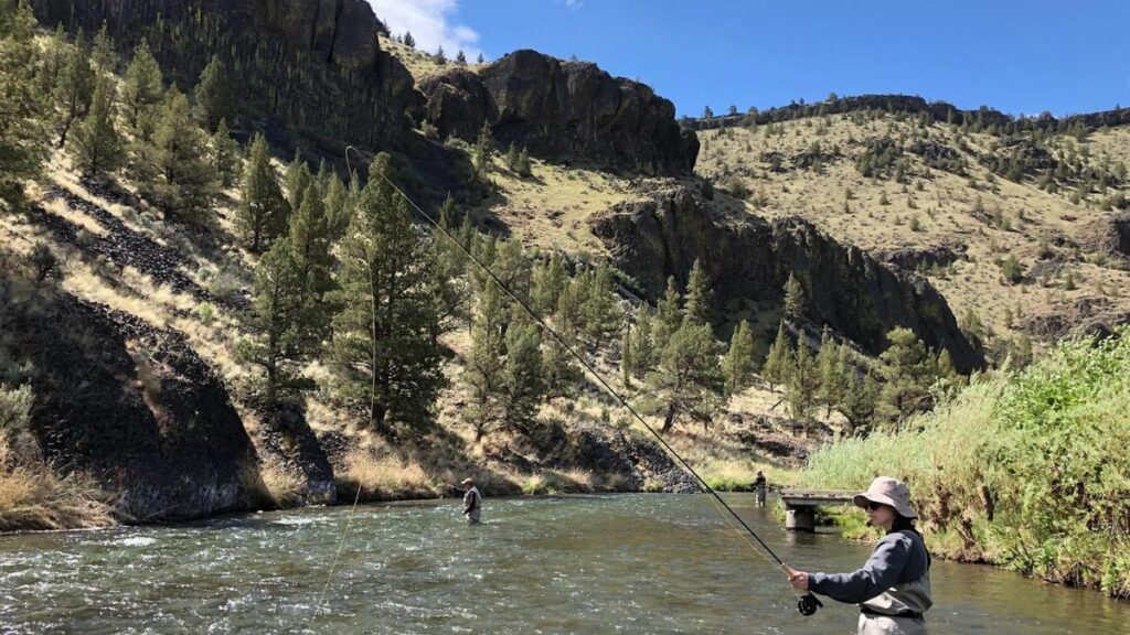 Fly fisherman casting on the Crooked River below Bowman Dam near Prineville, Oregon.