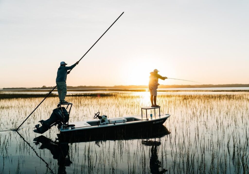 Local fishing guide navigating Louisiana marshes at sunrise during a private fishing charter.