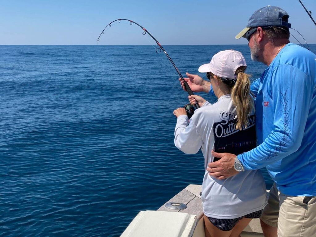 Independent fishing guide helping guests during a private fishing charter.