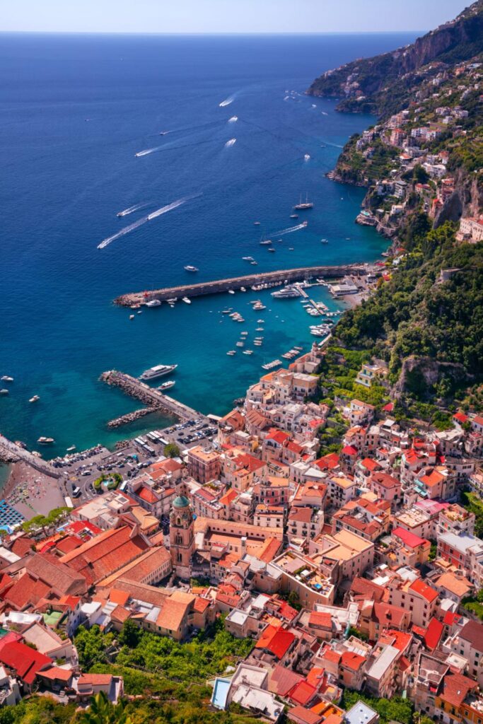 Private boat cruising below the dramatic cliffs of Italy's Amalfi Coast, one of the country's most spectacular coastal experiences.