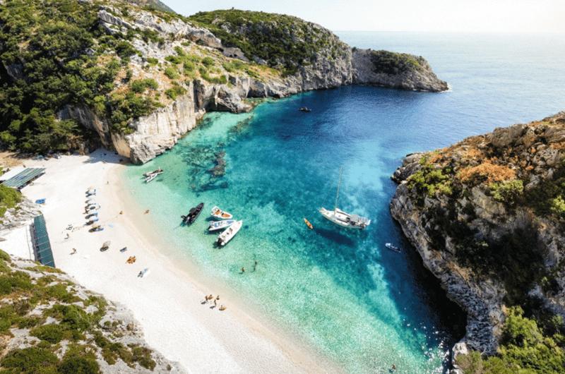 Hidden beach on Albania's Ionian coast reachable only by small boat or water taxi.