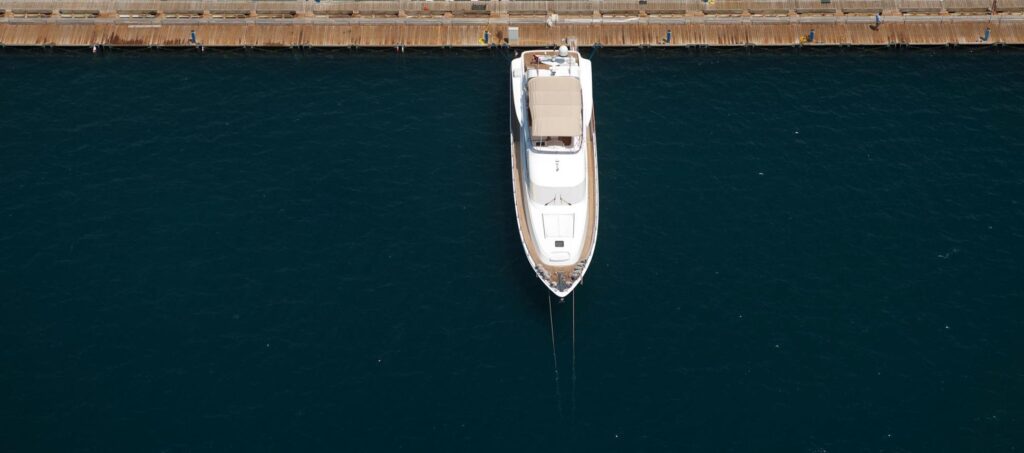 Recreational boat sitting unused in a marina, highlighting idle ownership costs.