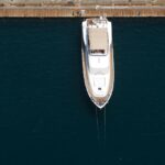 Recreational boat sitting unused in a marina, highlighting idle ownership costs.