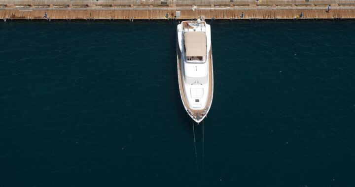 Recreational boat sitting unused in a marina, highlighting idle ownership costs.