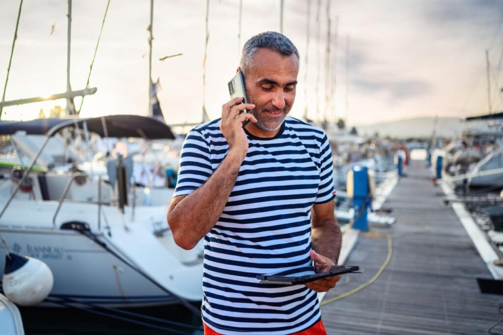 Boat owner managing tour bookings through mobile app