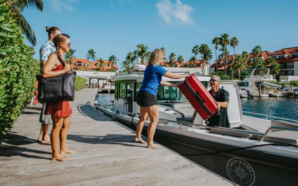 Guests enjoying a successful fishing charter aboard a center console boat.