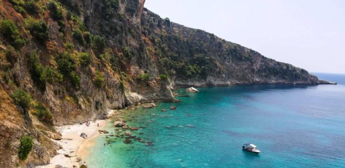 Rugged limestone cliffs along the Albanian Riviera seen from the Ionian Sea.