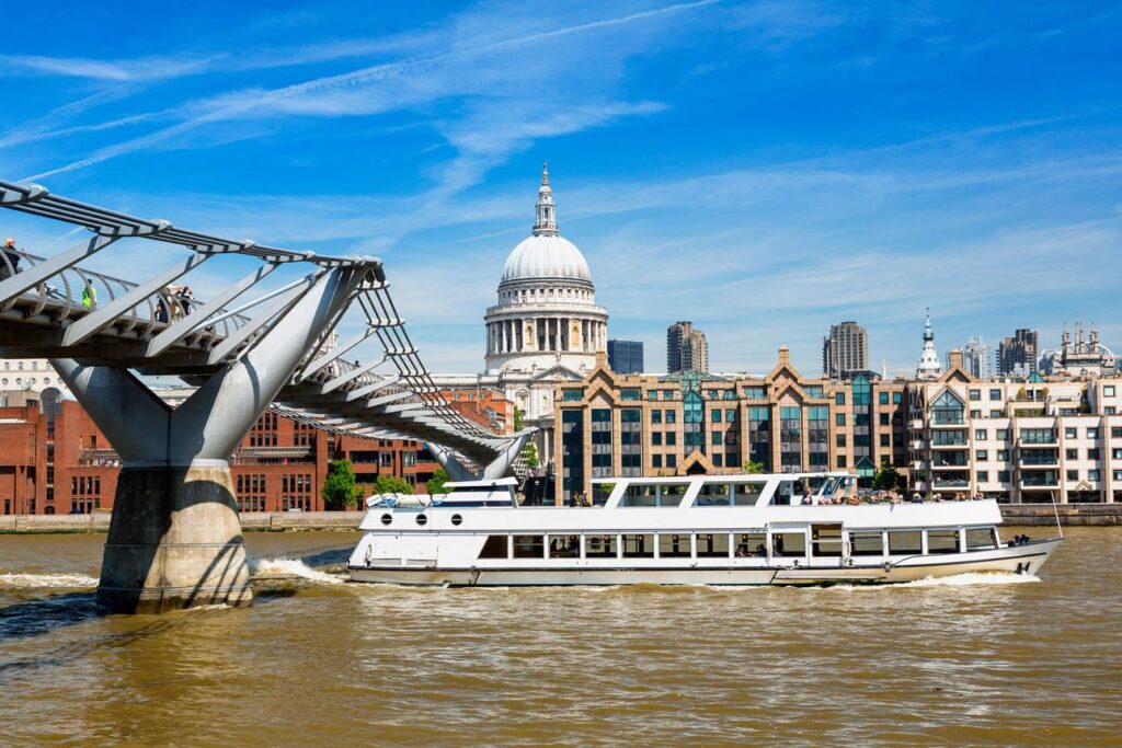 Boat cruising past St Paul's Cathedral on the River Thames in central London.